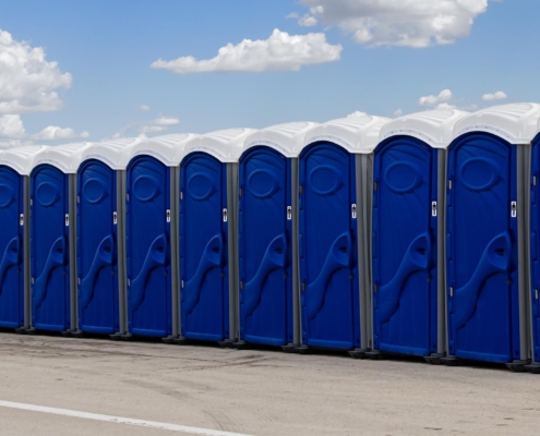 Side view of a row of portable toilets